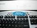 1993 Ford Taurus - A Ford logo is affixed to a computer keyboard, positioned below a Samsung monitor.