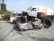 1986 Ford Bronco - Monster truck crushing several cars in a parking lot scene.