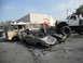 1986 Ford Bronco - A scene of destruction with multiple vehicles, including a van and a crushed car, under a monster truck.