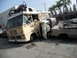 1986 Ford Bronco - Scene of multiple wrecked vehicles, including a bus and overturned car, with visible text on the bus.