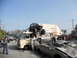 1986 Ford Bronco - A chaotic scene with multiple vehicles in disarray, including a dune buggy perched on a van.