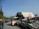 1986 Ford Bronco - A chaotic scene with an off-road buggy perched precariously on a stack of wrecked vehicles.
