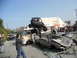 1986 Ford Bronco - A chaotic scene with multiple wrecked vehicles and an off-road buggy perched on top.
