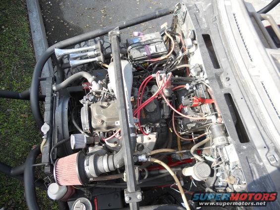 Engine bay with dual batteries, aftermarket air intake, and chrome air horns