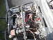 1986 Ford Bronco - The engine bay features dual batteries, an aftermarket air intake, and chrome air horns, suggesting custom modifications.