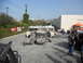 1986 Ford Bronco - A scene of destruction with a car overturned and an RV damaged, surrounded by onlookers.