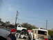 1986 Ford Bronco - A modified white pickup truck is seen in a junkyard with other vehicles and a person wearing a Santa hat.