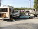 1986 Ford Bronco - Multiple vehicles and a bus are wrecked and piled up in a scene of destruction.