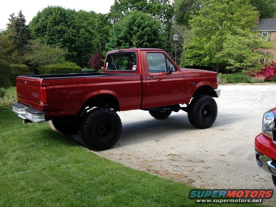 1996 Ford F-150 pickup truck, lifted with large tires, side view