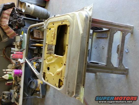 1967 Ford F-100 door removed and on a stand, interior yellow, exterior bare metal