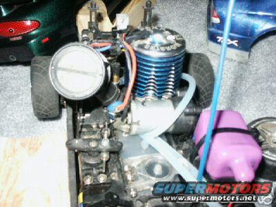 Close-up of a blue RC car engine with a purple fuel tank