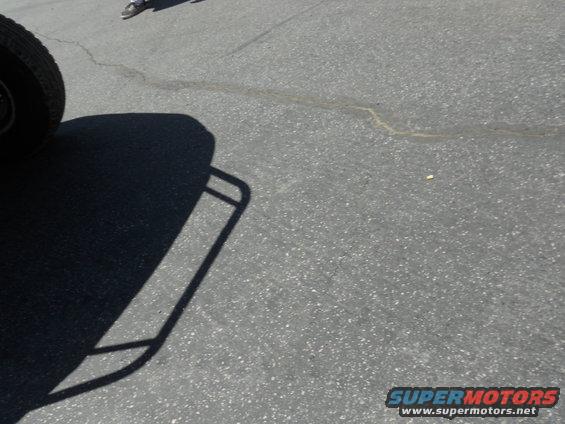 Tire and shadow of a vehicle on asphalt