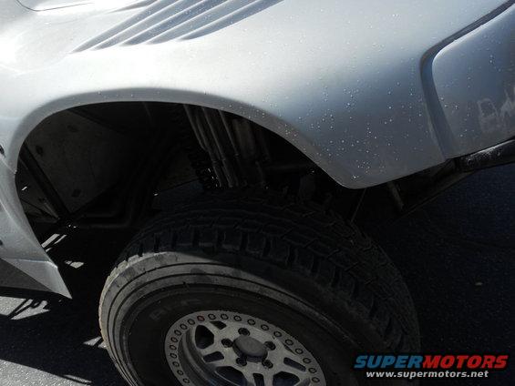 White off-road vehicle fender and tire with custom wheels