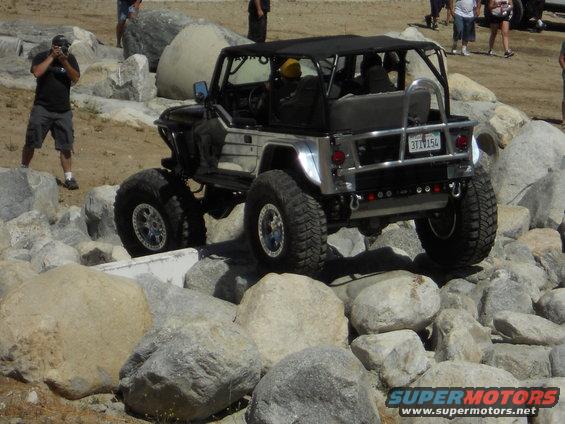 Modified Jeep Wrangler navigating rocks, rear view