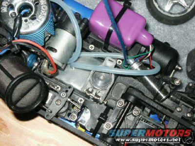 RC car engine with blue fins, purple fuel tank, and exposed wiring