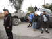 1986 Ford Bronco - Several people gather around two heavily modified trucks, one appearing to be a pickup and the other a large SUV or van.