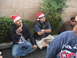 1986 Ford Bronco - Men in Santa hats gather outdoors, with one enjoying a churro during what appears to be a holiday event.