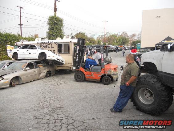 Forklift stacking cars, one on top of another