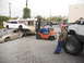 1986 Ford Bronco - A forklift is used to stack cars as part of a toy drive car crush event.