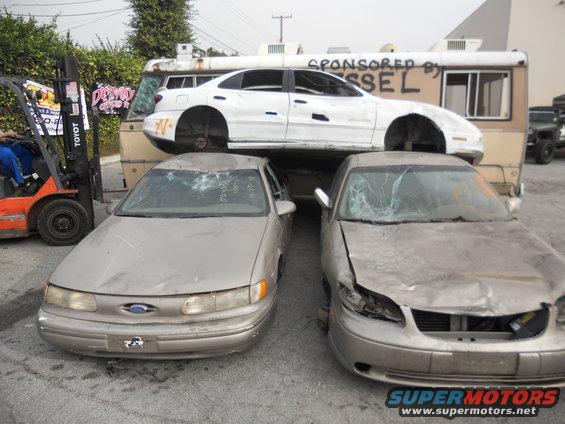 Gold Ford Taurus with a cracked windshield and dented front end