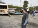 1986 Ford Bronco - A collection of damaged vehicles and a monster truck are gathered in a lot.