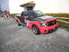 1986 Ford Bronco - This Ford F-150 pickup truck features Optima Batteries branding and a distinctive red and black paint scheme.