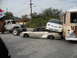 1986 Ford Bronco - Multiple vehicles are wrecked and piled up in a junkyard setting.