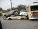 1986 Ford Bronco - A lifted pickup truck is crushing a sedan, which is also being crushed by a white car and a bus.