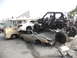 1986 Ford Bronco - A chaotic scene of multiple vehicles crushed and stacked, including a custom buggy.