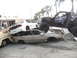 1986 Ford Bronco - A custom buggy is perched atop a stack of damaged vehicles in a junkyard setting.