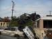 1986 Ford Bronco - A chaotic scene shows an off-road vehicle precariously balanced on a bus, with multiple cars crushed underneath.
