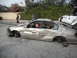 1986 Ford Bronco - This heavily damaged sedan has no wheels and a person in a Santa hat is in the driver's seat.