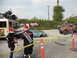 1986 Ford Bronco - A scene of destruction with multiple wrecked vehicles and a bus, cordoned off with caution tape.