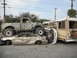 1986 Ford Bronco - A scene of vehicular destruction with a pickup truck on top of a sedan, beside a bus.