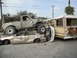1986 Ford Bronco - Multiple vehicles are piled up and wrecked, with a pickup truck on top of a sedan.
