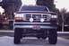 1992 Ford Bronco - Front view of a 1992 Ford Bronco with custom lights and a flag license plate frame.
