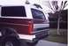 1992 Ford Bronco - Rear view of a maroon and white 1992 Ford Bronco, showing its distinctive body style and rear panel.
