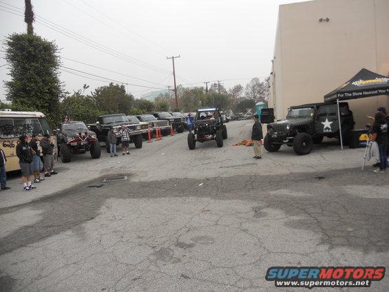 Several off-road vehicles, including a Jeep with a star emblem, parked outdoors