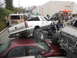 1986 Ford Bronco - A modified Chevrolet pickup truck is shown crushing a sedan, with onlookers observing the scene.