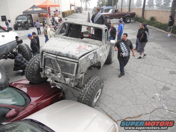 Mud-covered 1973 GMC pickup truck with oversized tires