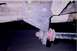 1992 Ford Bronco - Close-up view of a vehicle's suspension system, showing a bracket and shock absorber component.