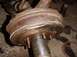 1992 Ford Bronco - Close-up of a heavily rusted brake drum and hub assembly with visible damage.