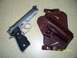 2000 Nissan Xterra - A silver pistol with a black grip lies beside a brown leather holster. Text on the image reads '05/16/2013 SUPERMOTORS www.supermotors.net'.