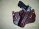 2000 Nissan Xterra - A pistol is shown in a leather holster. The image includes a date stamp and a website logo.