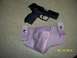 2000 Nissan Xterra - A handgun and holster are displayed on a speckled surface with a date stamp and website visible.