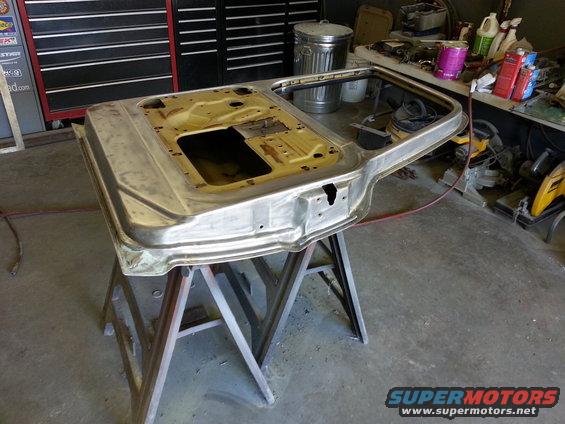 bare metal vehicle door on sawhorses in garage