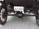 1909 Ford Model T - The rear axle and suspension system of a vintage automobile are visible, along with a license plate.