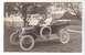 1909 Ford Model T - A couple poses in a 1909 Ford Model T convertible on a grassy lawn with a house and barn in the background.