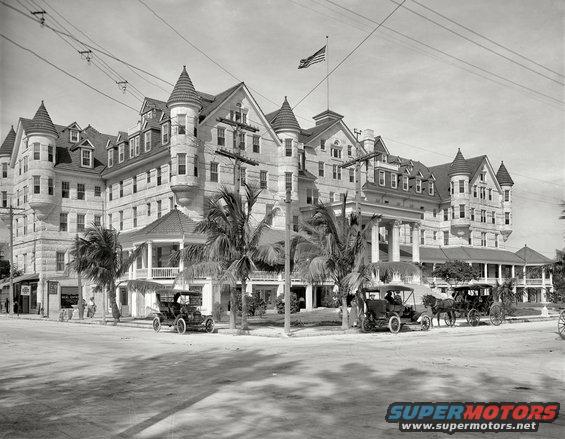 1909 Ford Model T parked on street in front of a large hotel