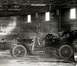 1909 Ford Model T - A 1909 Ford Model T is parked inside a wooden structure, its side profile clearly visible.